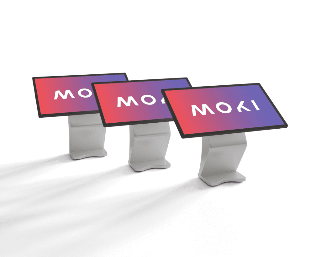 three standing tables with moki logo on the screens