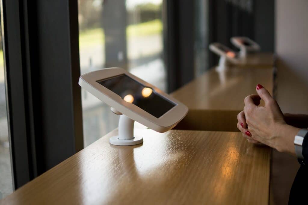 Side-by-side comparison of iOS and Android kiosk hardware managed through Moki