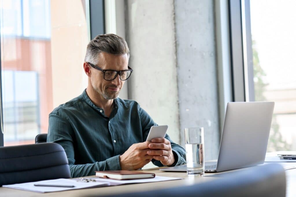 IT administrator reviewing MDM compliance policies for a kiosk device fleet